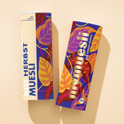 Zwei mymuesli Bio Herbst Müsli Dosen mit herbstlichen Blättern als Design von der Seite
